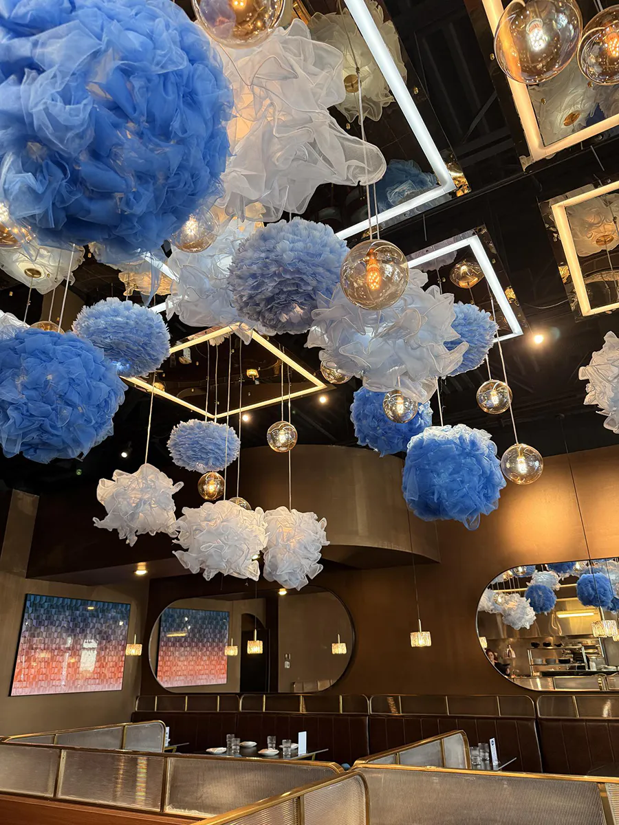 Modern dining room with blue and white ceiling decor and warm pendant lighting at 21 Raw Bar Taphouse & Grill, a Seafood Restaurant in Greenville